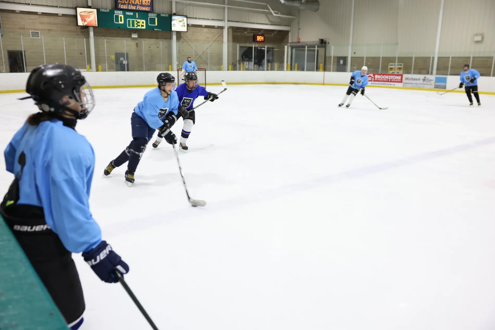 Hockey player in a white jersey skating with the puck