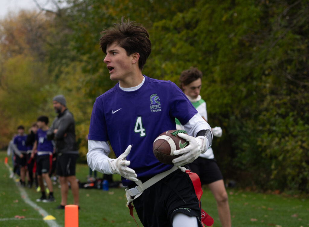 student playing football