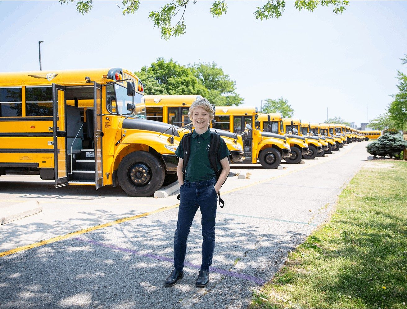student boy in front of buses