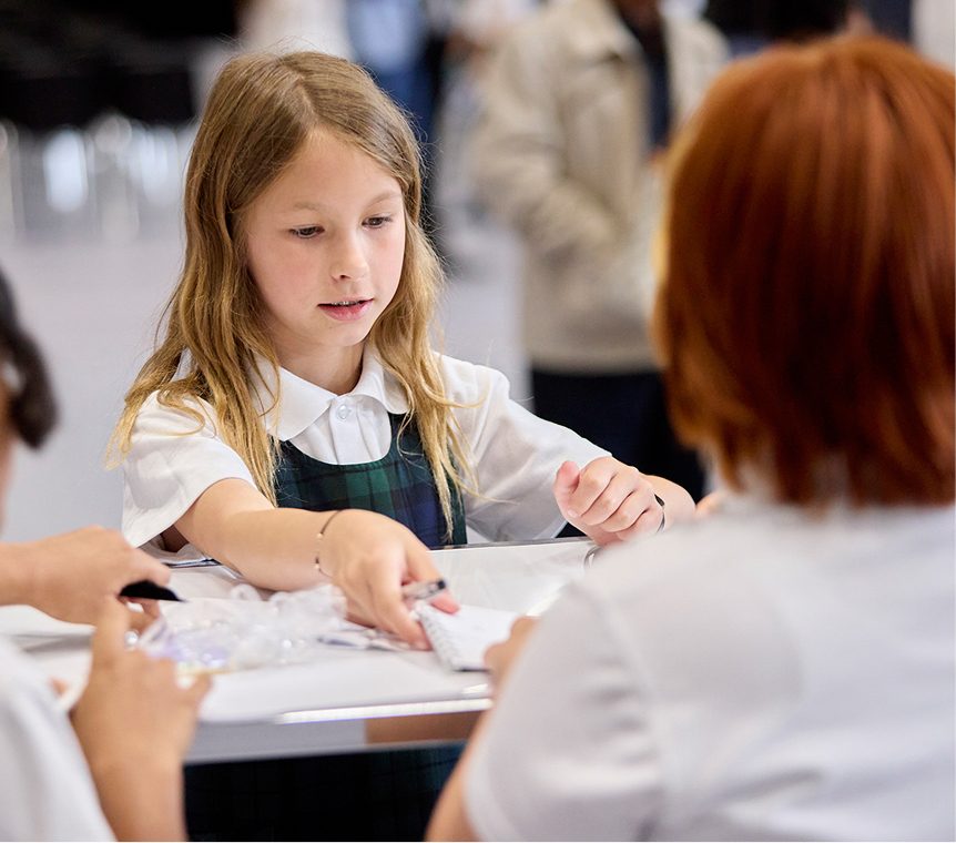student sitting at desk with books