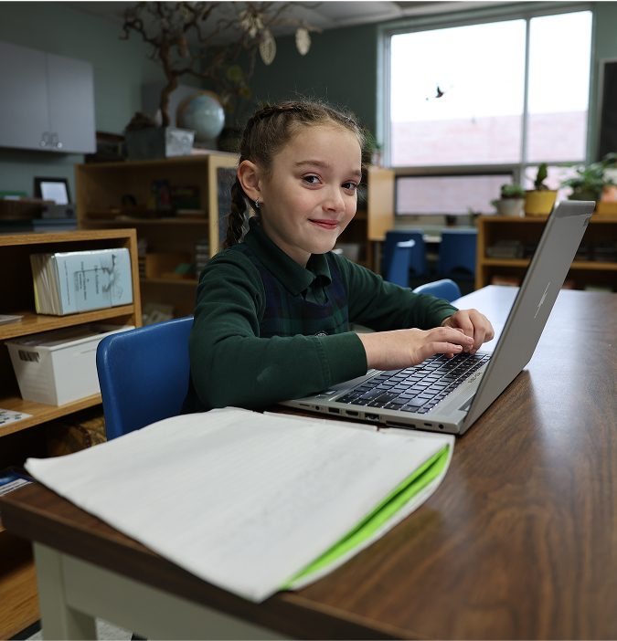 student on laptop on desk