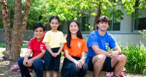 students sitting on bench outside