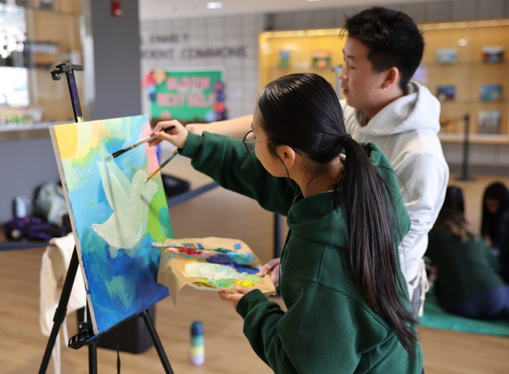 students painting together
